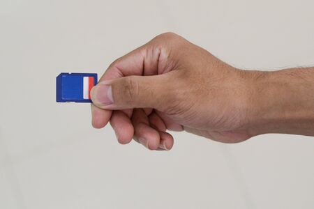 hand holding sd memory card.