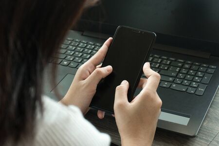 Cropped image of professional business woman working at home office via laptop, manager using portable computer device  work process conceptの写真素材