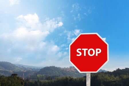 Stop sign on the blue sky.Stop warning traffic sign on a roadの写真素材