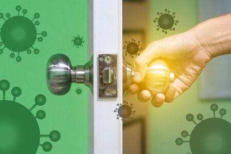 Woman hand open dor. Dont Clear for killing bacteria and virus before open the door. Selective focus.Stop Covid-19 concept.の写真素材