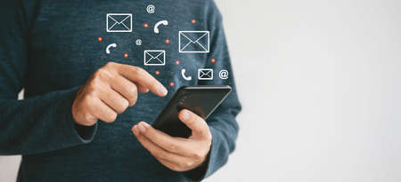 Man using cellphone for searching data and social media on internet. Happy Asian man using...