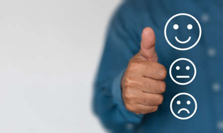 Businessmen choose to rating score happy icons with copy space. Customer service experience and business satisfaction survey conceptの写真素材