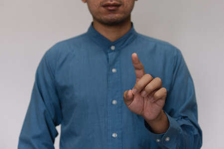 Young handsome man wearing light blue shirt  with different behaviors at workの写真素材