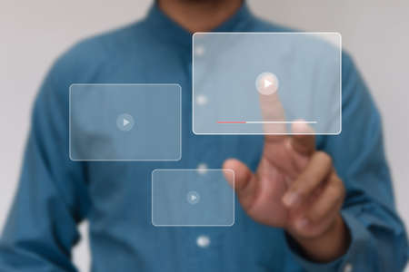 Close up hands play screen video streaming online for watching video on internet live concert show or tutorial. Technology business investment and education conceptの写真素材