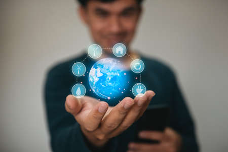 Man holding planet Earth as blue, ecological, and renewable energy world concept.の写真素材