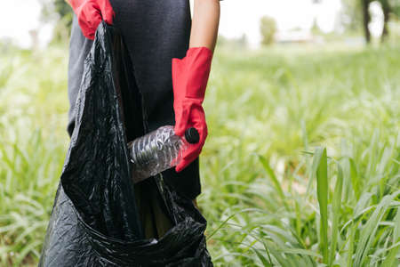 Boy man hand pick up plastic bottle in the forest. nature conservation and Environment concept.の写真素材