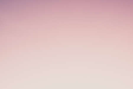 Abstract gradient sunrise in the sky with blue smooth blurred purple and orange natural background.の写真素材