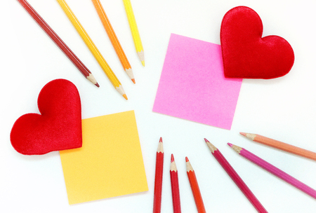 Color post-it note with Red fabric hearts and color pencilの写真素材