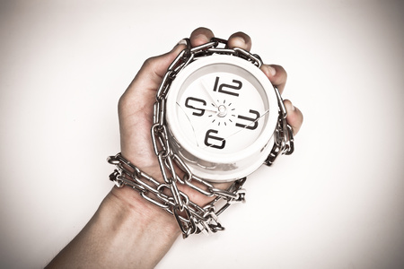 A clock chained in a handの写真素材