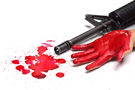 A rifle with bloody hands and blood dropsの写真素材