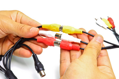 hands holding tv cable jack