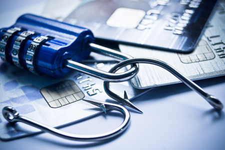 security lock with password and fish hooks on credit cards - phishing protection conceptの写真素材