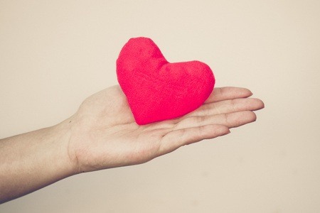 hands holding a red heartの写真素材