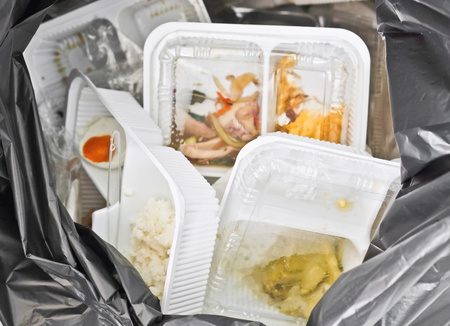 foam and plastic food container in the bin / environmental problemsの写真素材
