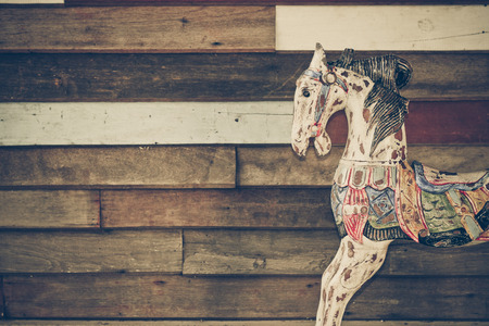 old wooden horse with wood plank wall backgroundの写真素材