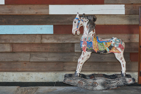 old wooden horse with wood plank wall backgroundの写真素材