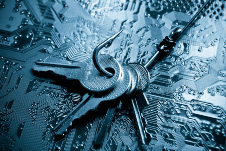 a fish hook with keys on computer circuit board / phishing / computer data theft concept