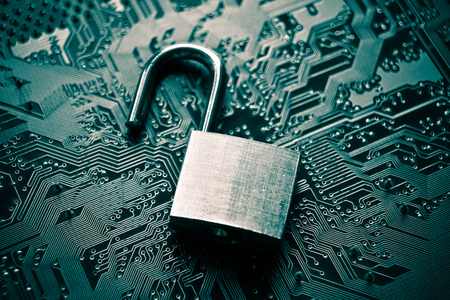 unlock security lock on computer circuit board - computer security breach conceptの写真素材