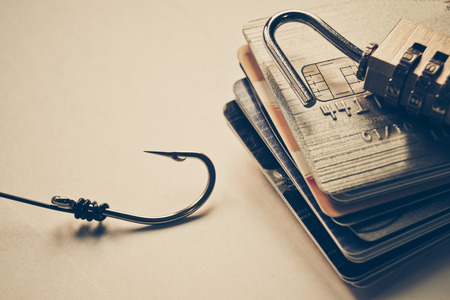 credit card phishing - credit cards with broken security lock and a fish hookの写真素材