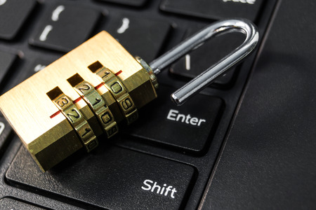 metal security lock with password on computer keyboard - security concept in computer