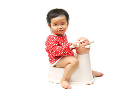 Asian child on potty play - learning to use toiletの写真素材