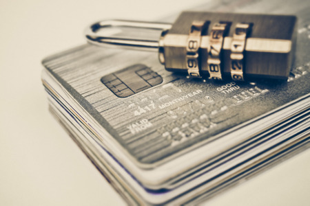 Security locks with password on piles of credit cards  Credit card data encryption conceptの写真素材