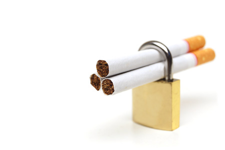 Cigarettes in a security lock - stop smoking conceptsの写真素材