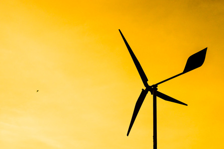 Wind mill silhouette with sunset lightの写真素材