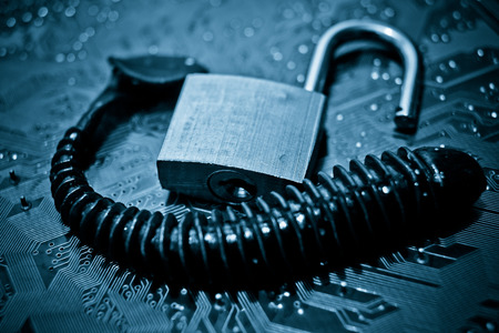 computer security breach due to worm attack - worm on computer circuit board with open security lock