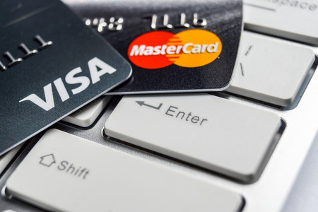 Close up of VISA and Mastercard credit card on white computer keyboardのeditorial素材