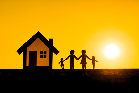 Paper cut of family and a house with sunset background  Family Life Insurance  Protecting family  Family conceptsの写真素材