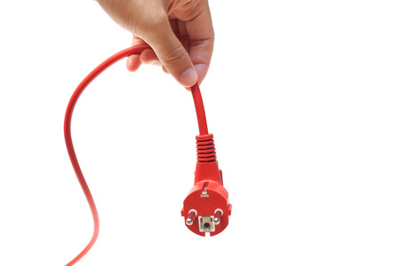 hand unplug a red plug / Save energy conceptの写真素材