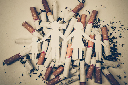 paper cut of family destroyed by cigarettes / drugs destroying family concept / world no tobacco dayの写真素材