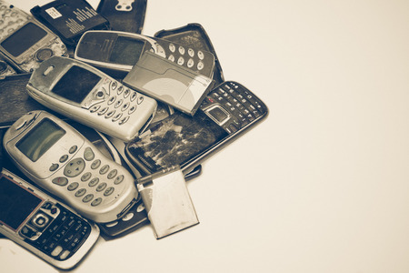 Old cellphones and battery - Electronic waste concept