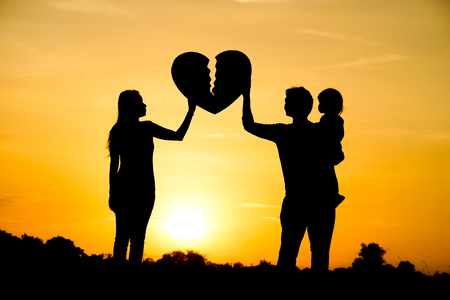 Silhouette of a family comprising a father, mother, and a child  Family love conceptの写真素材