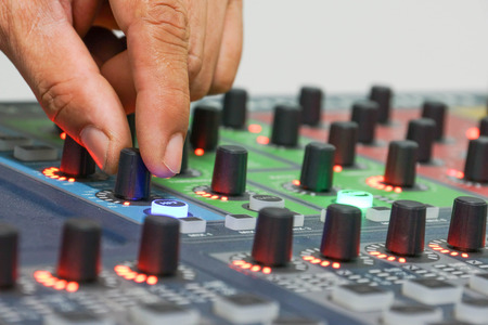 hands adjusting audio controller