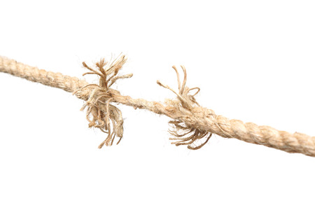 Rope nearly torn apart isolated - risk concept