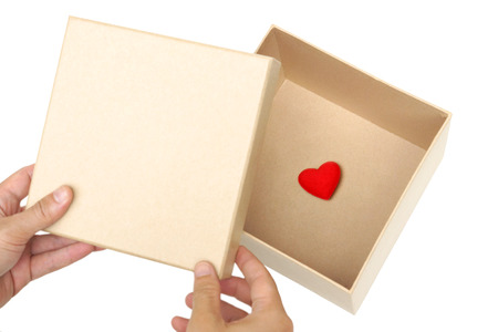 Hand opening a box of with a tiny red heart inside / Surprised love concept