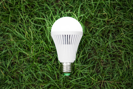 A turned on LED light bulb / Green energy concept / Using environmentally friendly appliances...