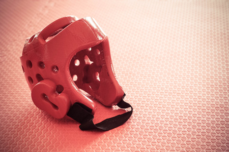 Taekwondo head guard on a training mat in old vintage toneの写真素材