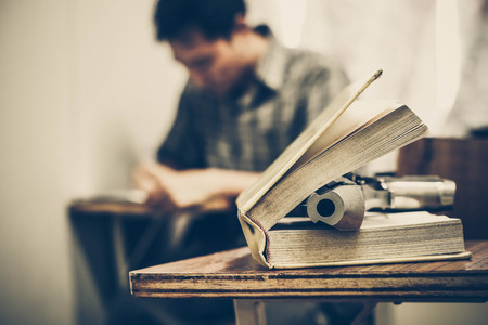 A gun on a textbook / gun allowed in some US university conceptの写真素材