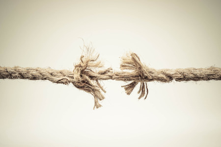 Rope nearly torn apart isolated - risk conceptの写真素材