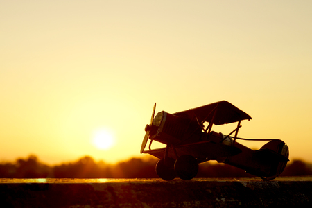 sunset silhouette of old bi planeの写真素材