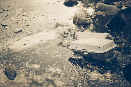 Water pollution - Plastic and foam garbage floating on the surface of the river - Environmental problem caused by human activityの写真素材