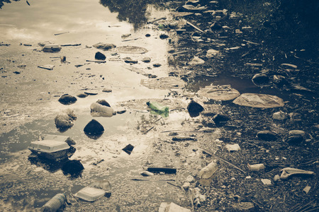 Water pollution - Plastic and foam garbage floating on the surface of the river - Environmental problem caused by human activityの写真素材