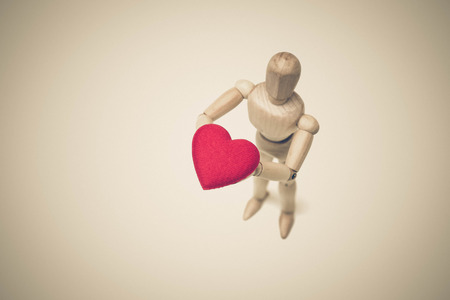 Wood Figure Mannequin holding a red heart vintageの写真素材