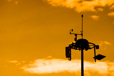 Silhouette of Weather measurement unit with blue sky background / Low Level Wind Shear Alert System : LLWASの写真素材