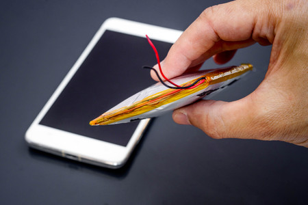 Smartphone battery swelling / Risk of using smartphoneの写真素材