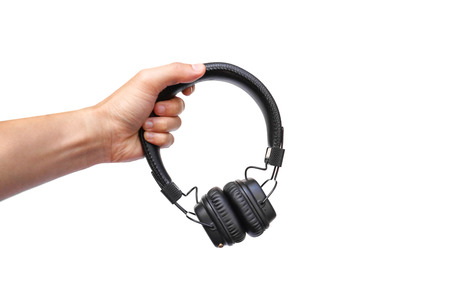 Hand holding a wireless headphoneの写真素材