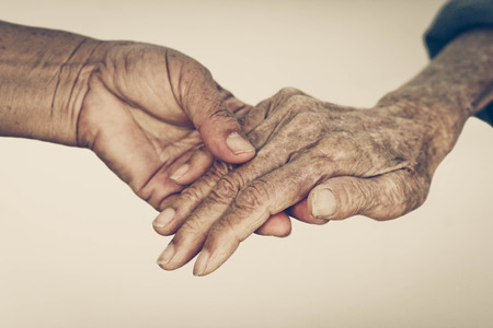Elderly people holding hands together isolatedの写真素材